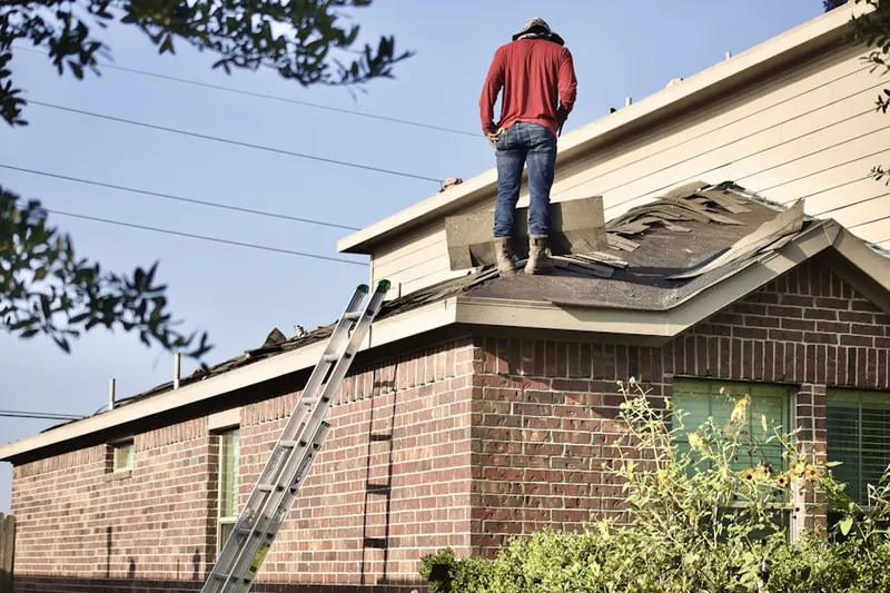 Professional roofer working on a residential roof in Outville